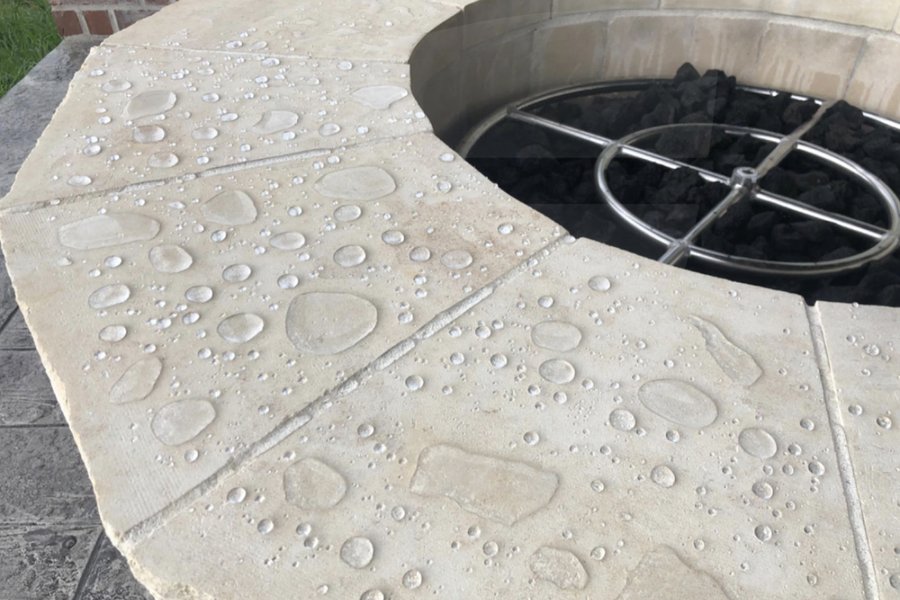 Sealant protecting a stone firepit surround